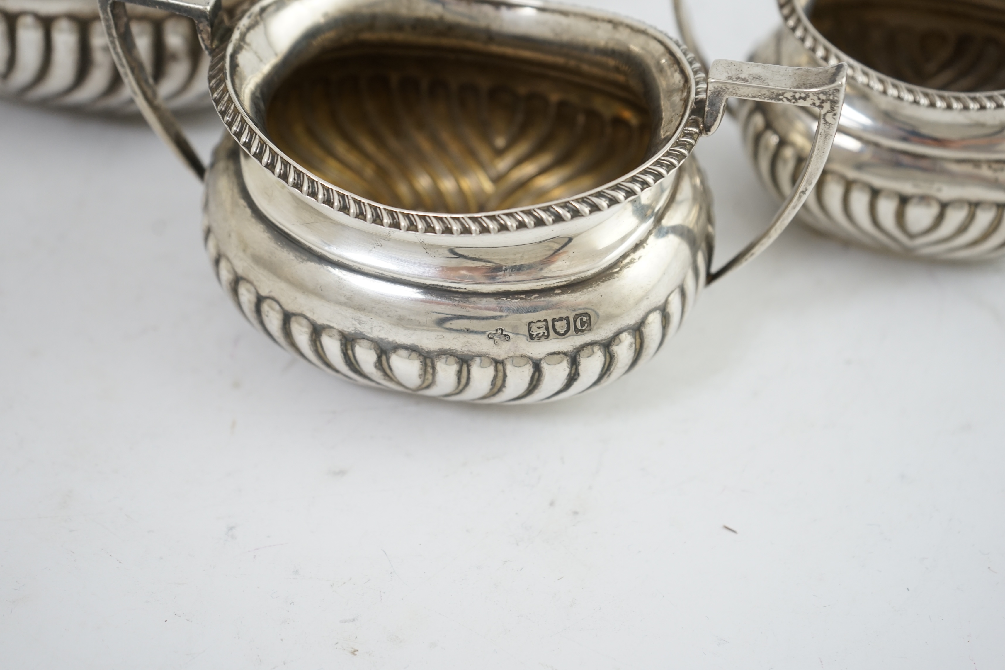 A late Victorian demi-fluted silver three piece tea set, by Horace Woodward & Co Ltd